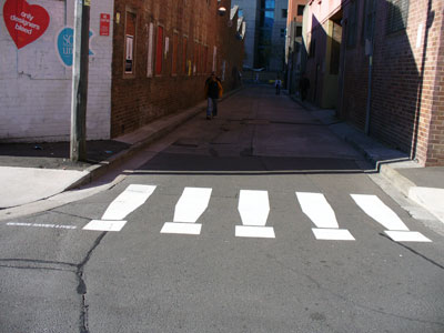 Fake pedestrian crossing, â€˜Design saves livesâ€™, an entrant in the Eye Saw exhibition in Omnibus Lane, Ultimo during Sydney Design Week, 2006 (photo by meganix).