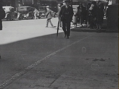 A stopping line at the intersection of Market and Pitts Streets in Sydney, marked out with metal studs, 1929 (City of Sydney Archives photograph, SRC7806, file 034\034213).