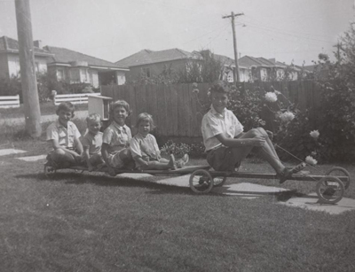 Children on a billycart with a trailer in the Melbourne suburb of Mount Waverley, 1961. 